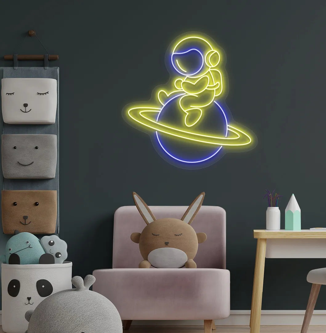 Yellow astronaut sitting on planet LED neon sign for space-themed bedroom.