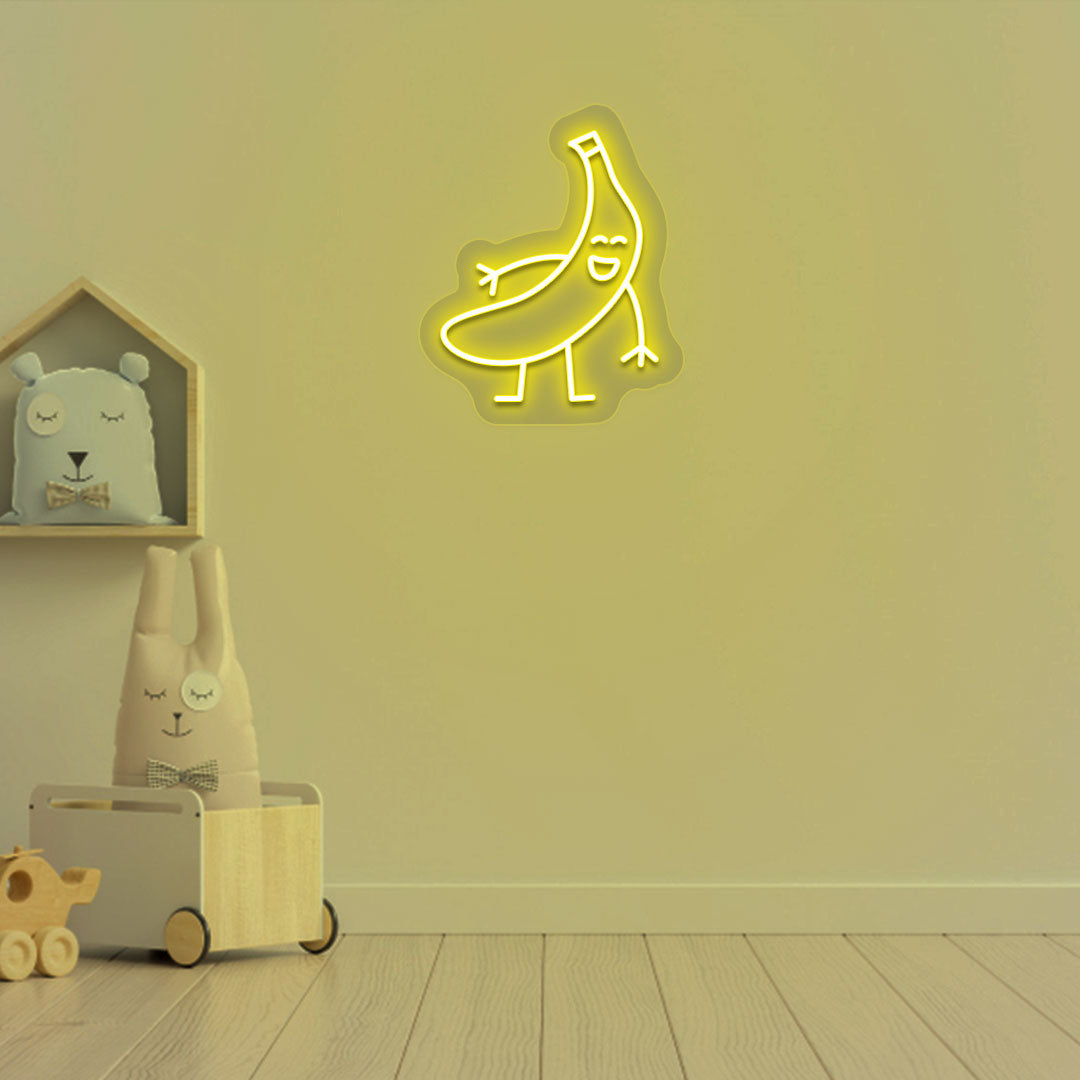 Playroom wall decor with a banana neon sign in yellow LED. Perfect for kids’ rooms, nursery wall décor, and bedroom décor.