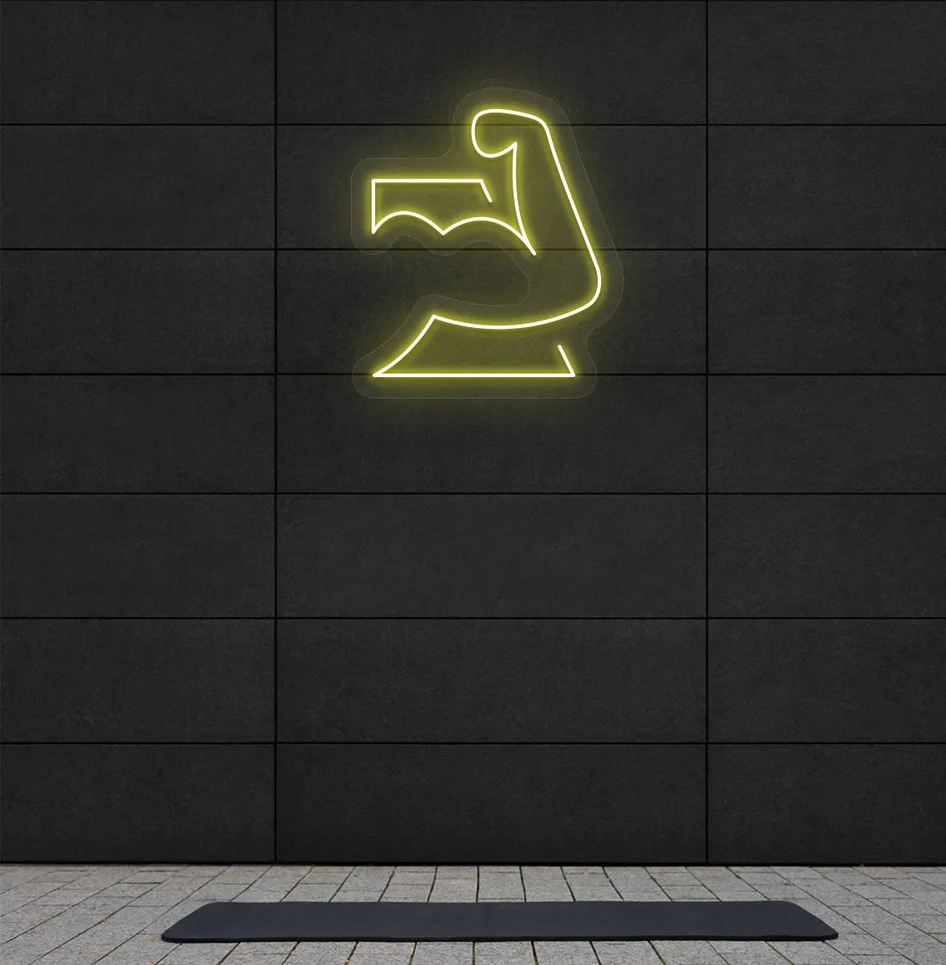 Trendy strong body neon sign in yellow mounted on fitness wall.