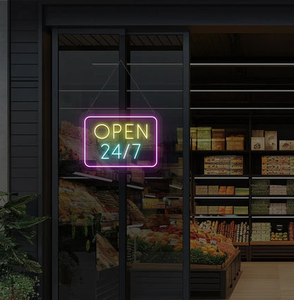 Image of storefront glass door with "24/7 open" neon sign glowing ice blue.