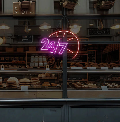 Trendy 24/7 with clock neon sign in pink hanging on bakery storefront glass.