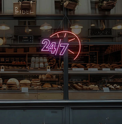Purple LED 24/7 clock neon sign glowing on bakery glass storefront.