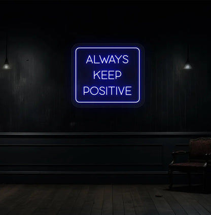 Image of an "Always keep positive" neon sign in blue color mounted on aesthetic wall.