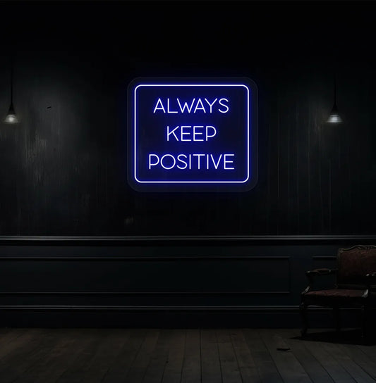 Image of an "Always keep positive" neon sign in blue color mounted on aesthetic wall.