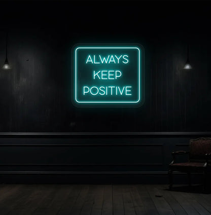 Image of an "Always keep positive" neon sign in ice blue color mounted on aesthetic wall.