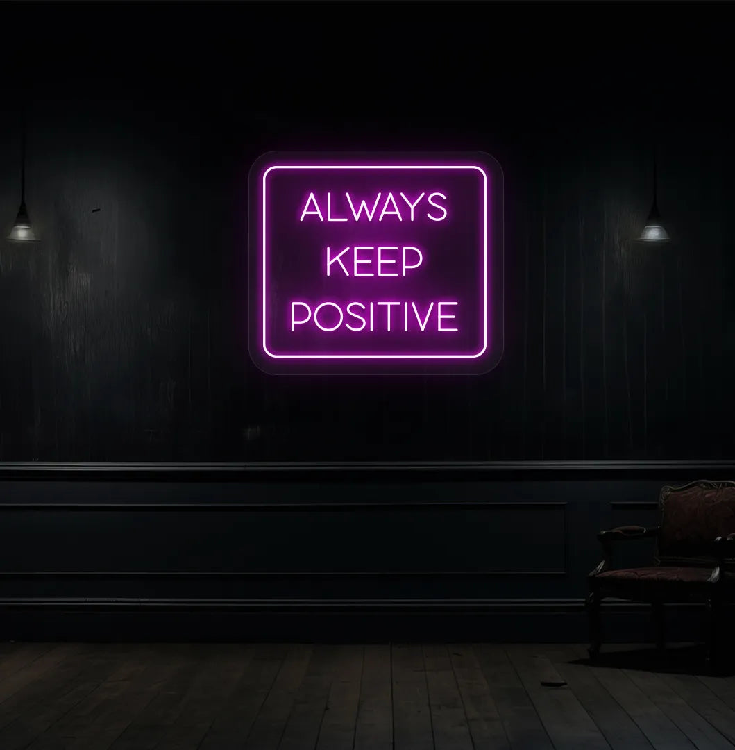 Image of an "Always keep positive" neon sign in pink color mounted on aesthetic wall.