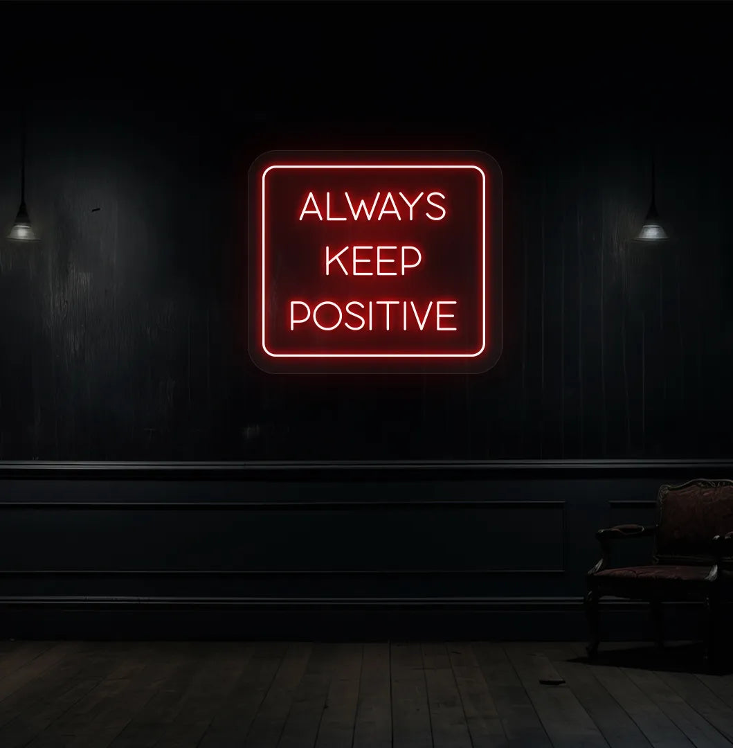 Image of an "Always keep positive" neon sign in red color mounted on aesthetic wall.