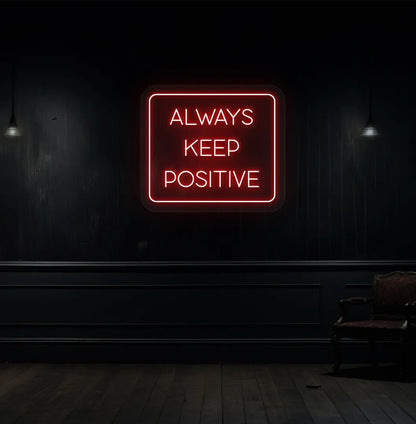 Image of an "Always keep positive" neon sign in red color mounted on aesthetic wall.