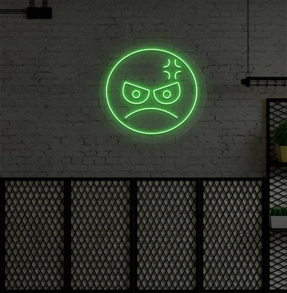 Modern wall decor with angry emoji neon sign mounted on a wall in green.