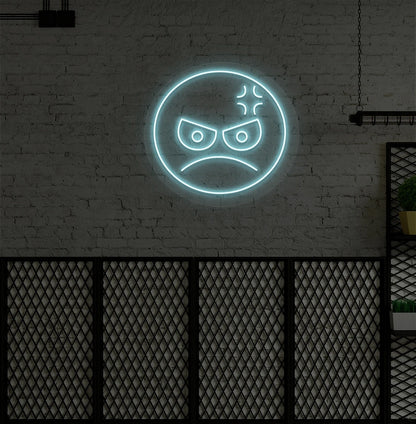 Image of an angry emoji neon sign glowing on aesthetic wall in ice blue color.