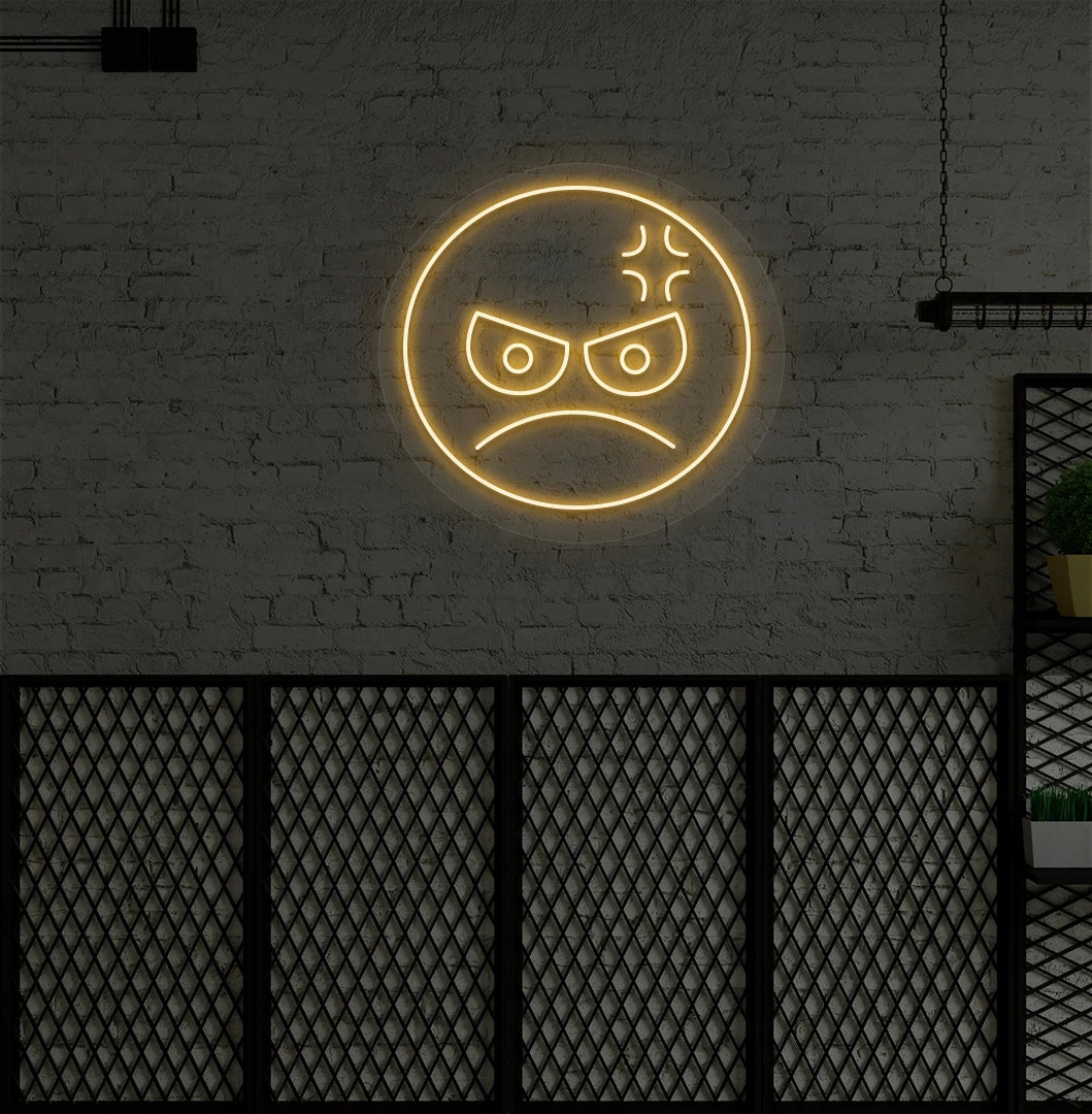 Modern wall decor with angry emoji neon sign mounted on a wall in orange.