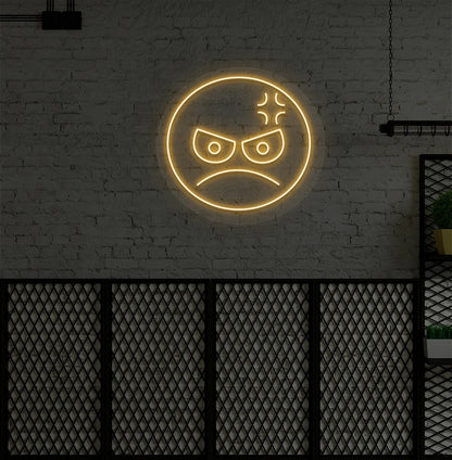 Modern wall decor with angry emoji neon sign mounted on a wall in orange.