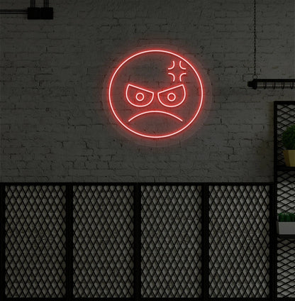 Image of an angry emoji neon sign glowing on aesthetic wall in red color.