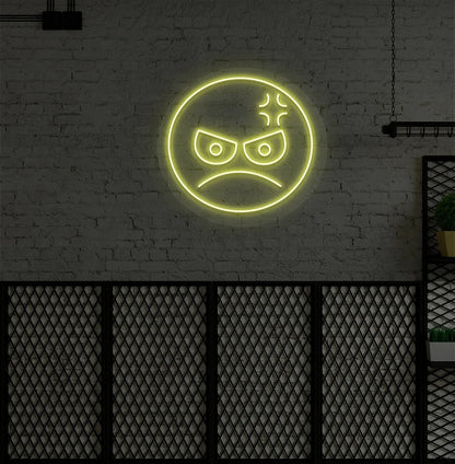 Modern wall decor with angry emoji neon sign mounted on a wall in yellow.