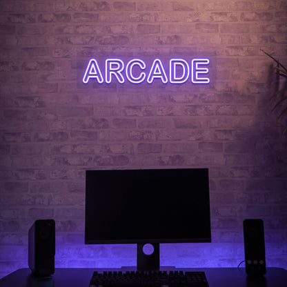 Image of an arcade LED neon sign glowing on a gaming room wall in purple.
