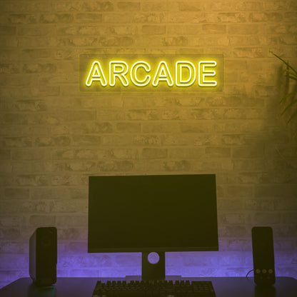 Image of an arcade LED neon sign glowing on a gaming room wall in yellow.