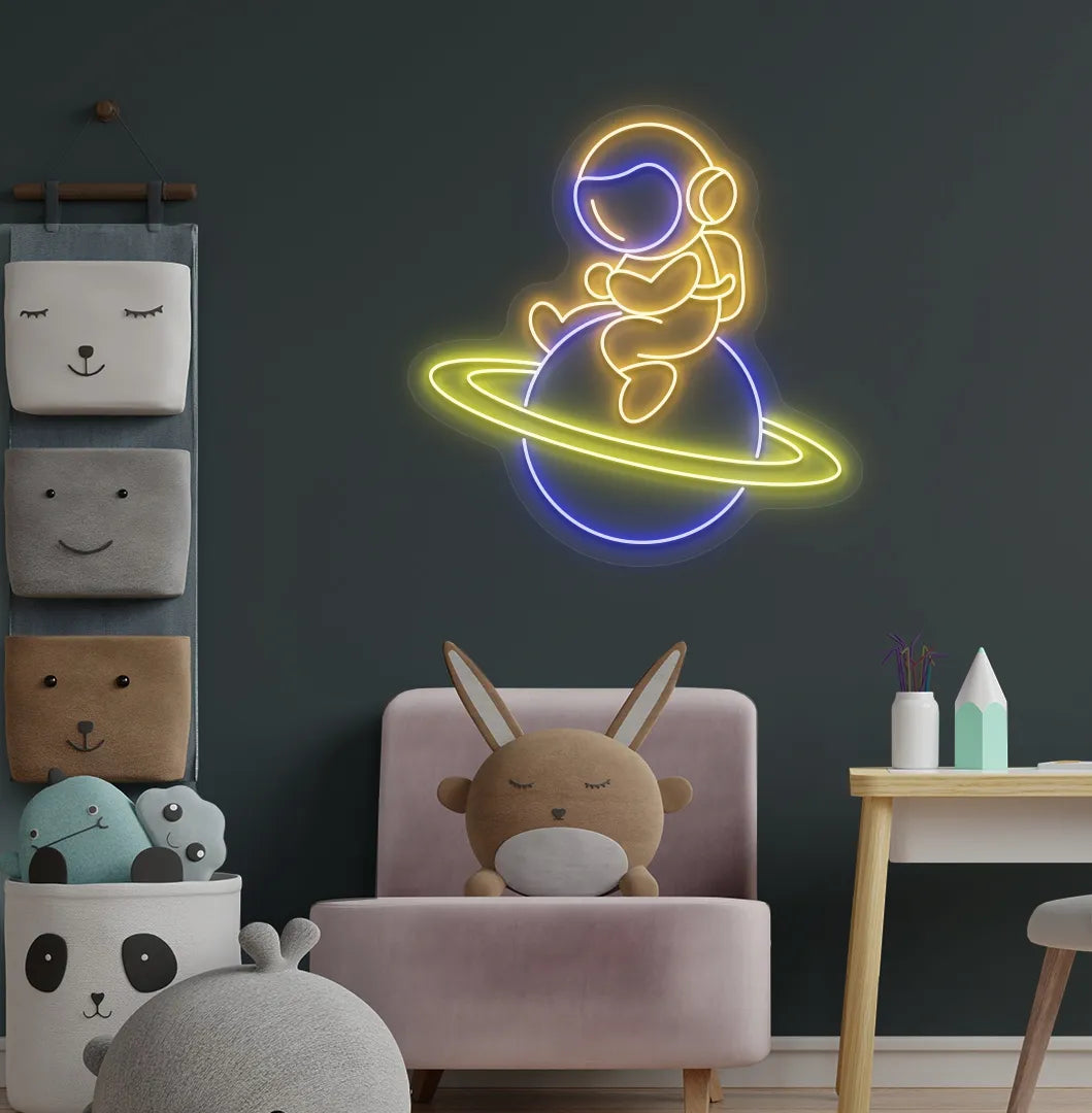 Orange astronaut sitting on planet LED neon sign for space-themed bedroom.