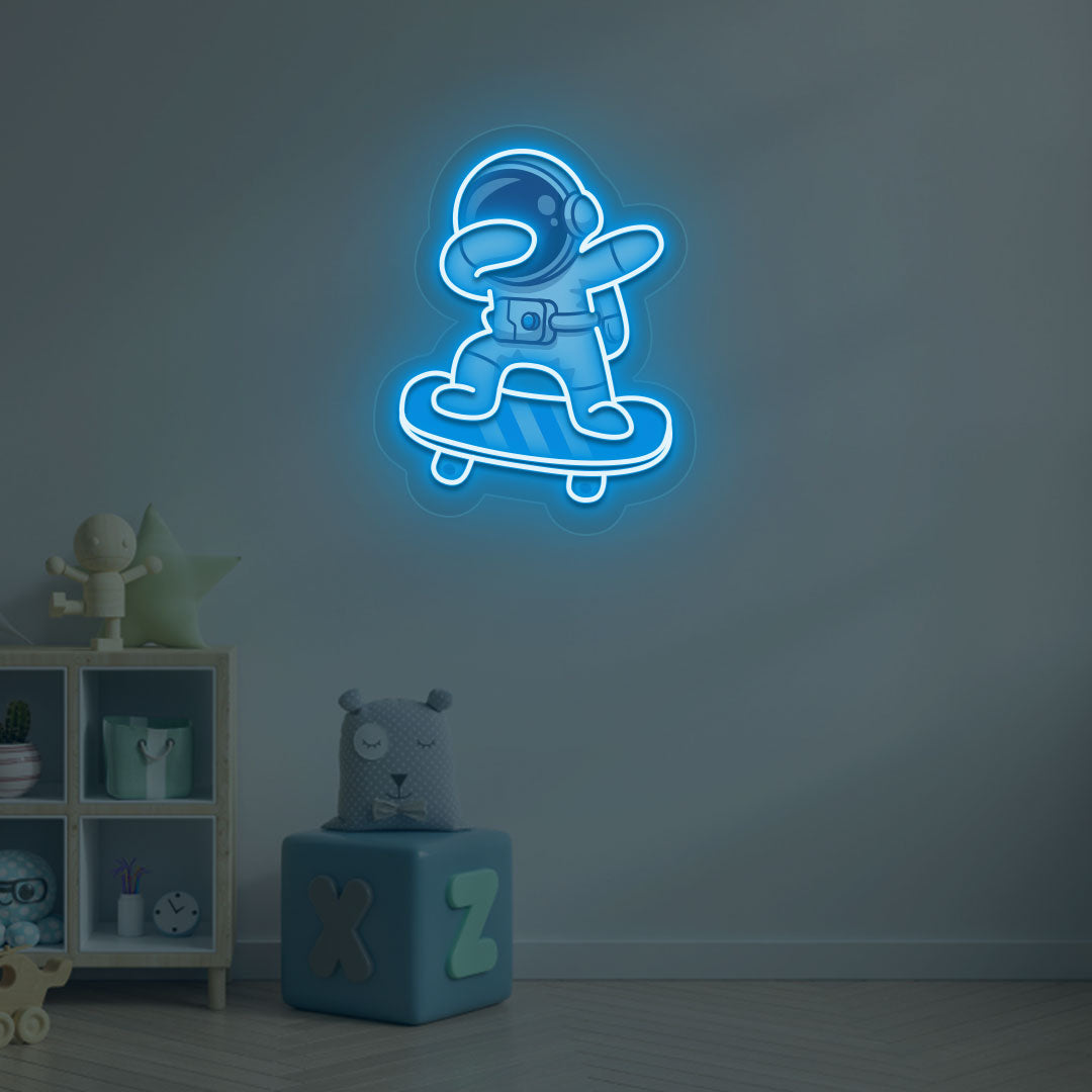 Image of an astronaut skateboard neon sign mounted on a kid's bedroom wall in ice blue color.