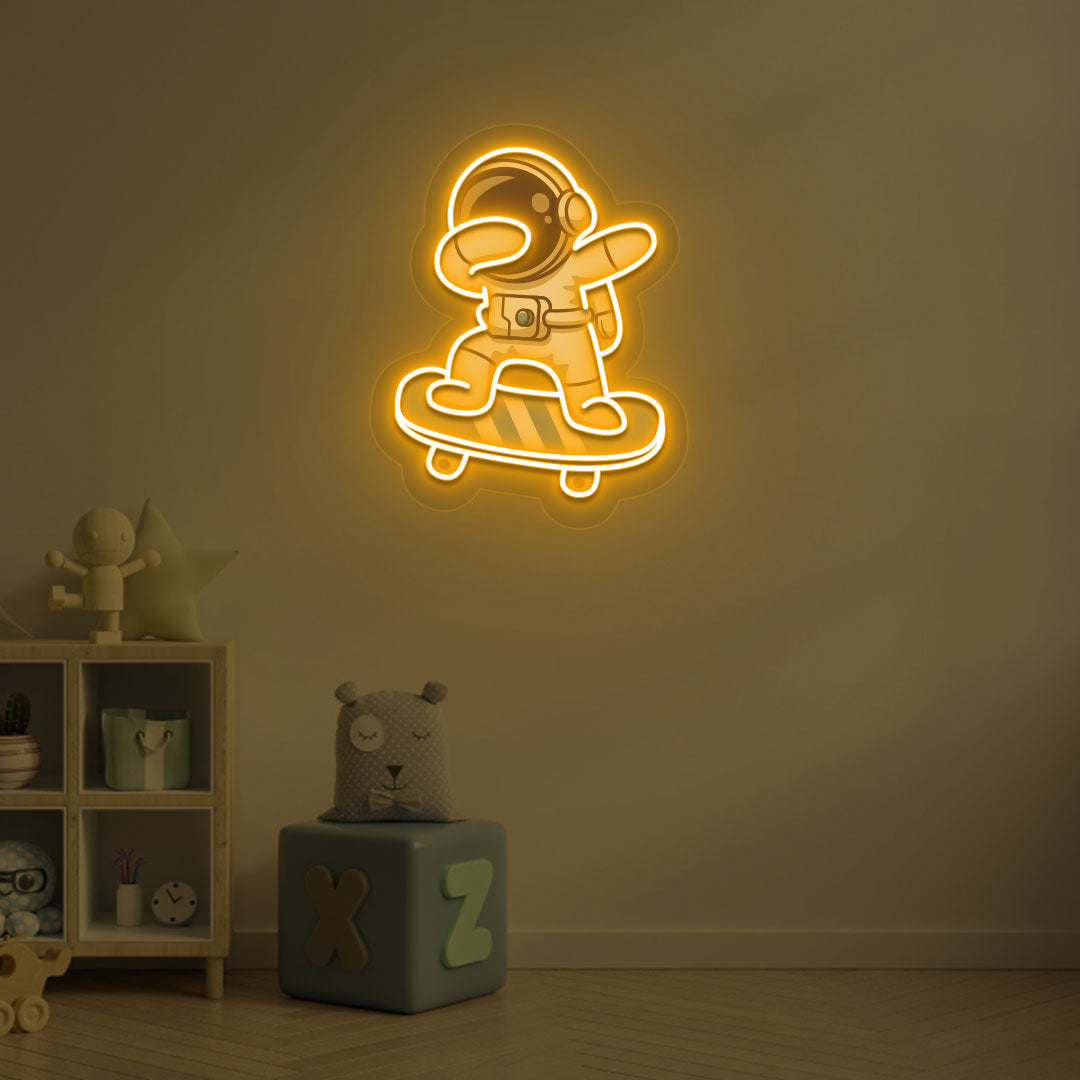 Space-themed kids' room wall with astronaut on skateboard neon sign in orange LED.