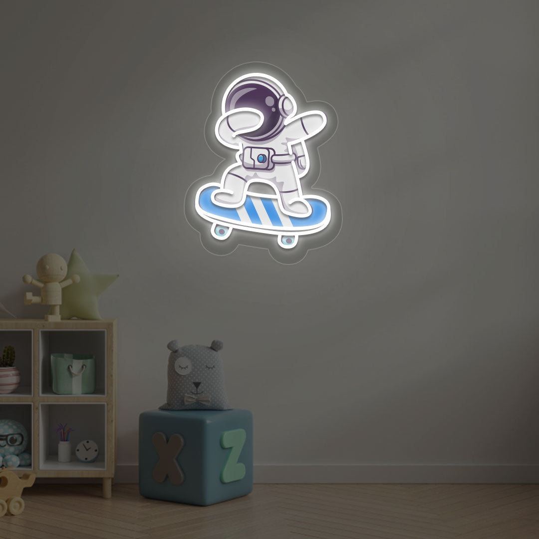 Image of an astronaut skateboard neon sign mounted on a kid's bedroom wall in white color.