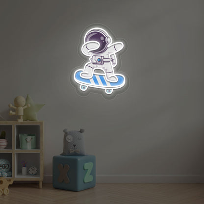 Image of an astronaut skateboard neon sign mounted on a kid's bedroom wall in white color.
