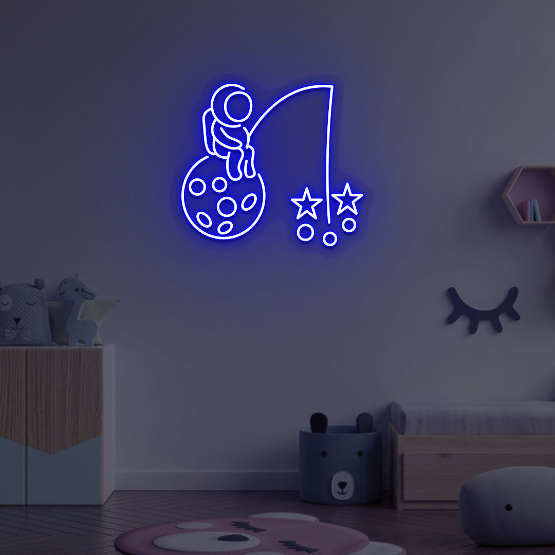 A creative blue LED astronaut neon sign catching stars glowing on a kid's room wall. Perfect for playrooms, space-themed interiors, and bedroom wall décor.