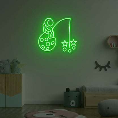 A creative green LED astronaut neon sign catching stars glowing on a kid's room wall. Perfect for playrooms, space-themed interiors, and bedroom wall décor.