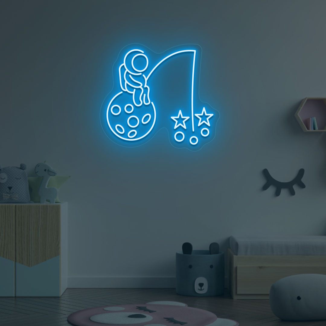 A creative ice blue LED astronaut neon sign catching stars glowing on a kid's room wall. Perfect for playrooms, space-themed interiors, and bedroom wall décor.