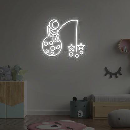 Image of an astronaut with a stars LED neon sign on a kid's room wall in white color.