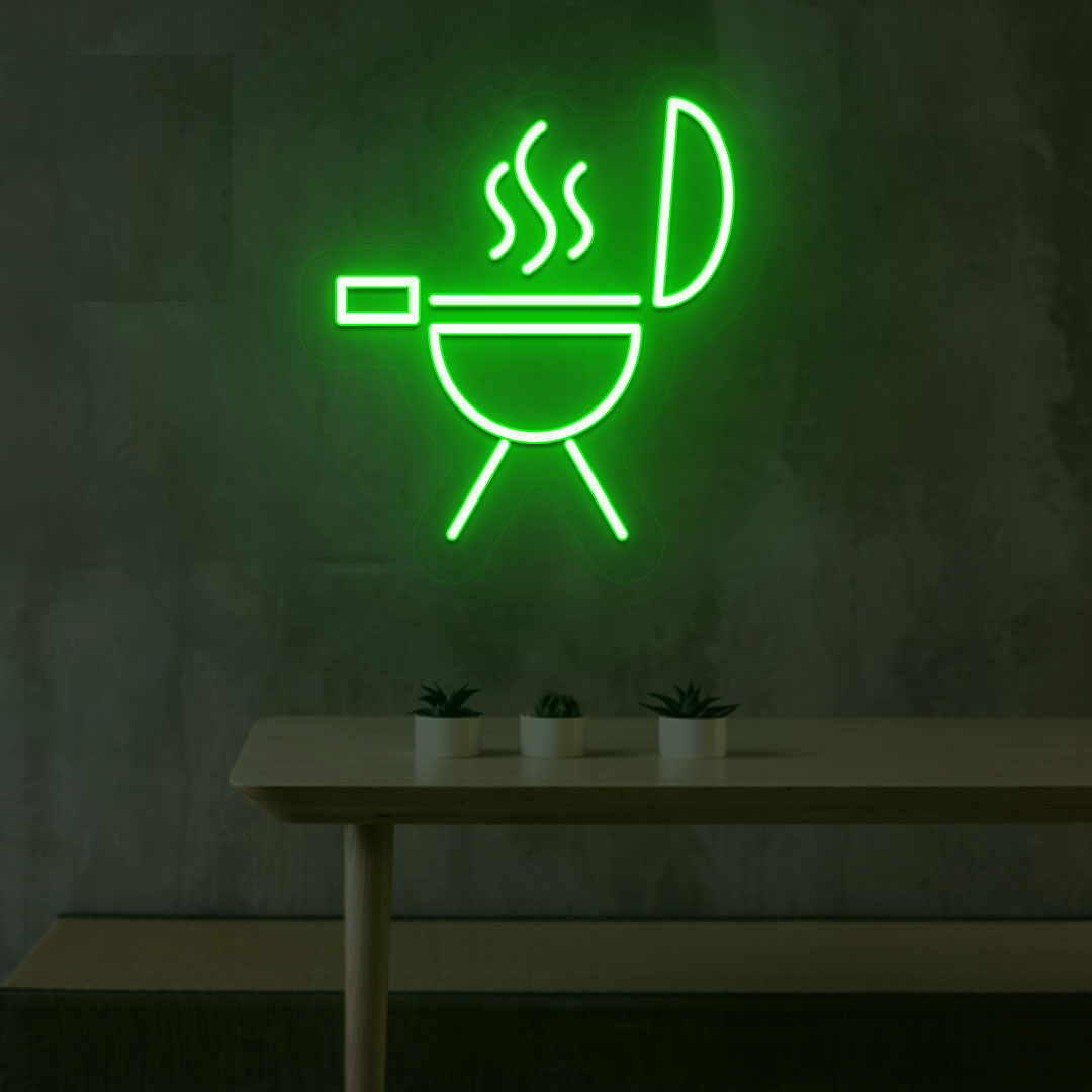Image of a BBQ neon sign grill machine symbol glowing on a wall in green color.