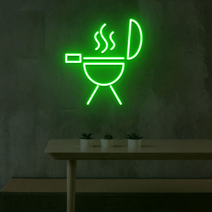 Image of a BBQ neon sign grill machine symbol glowing on a wall in green color.