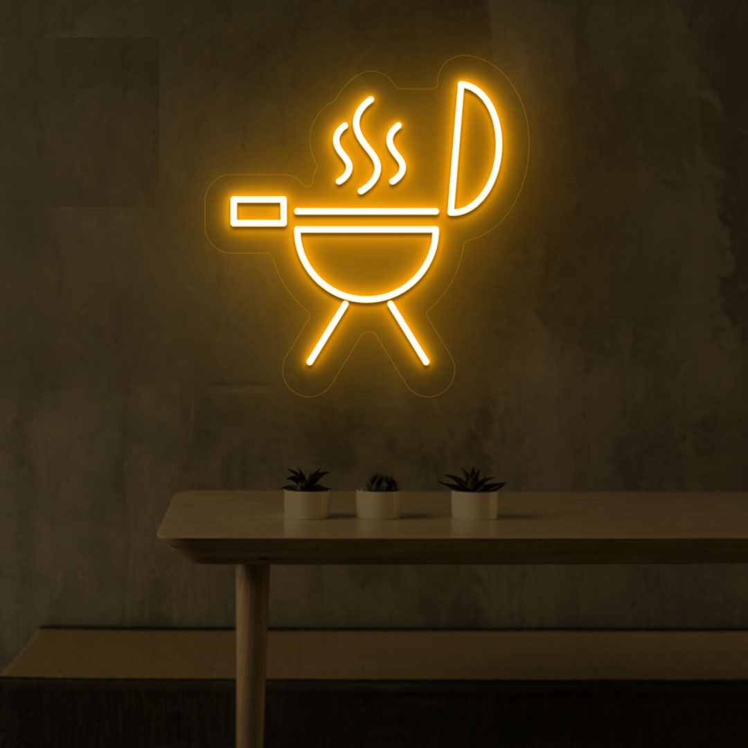 Image of a BBQ neon sign grill machine symbol glowing on a wall in orange color.