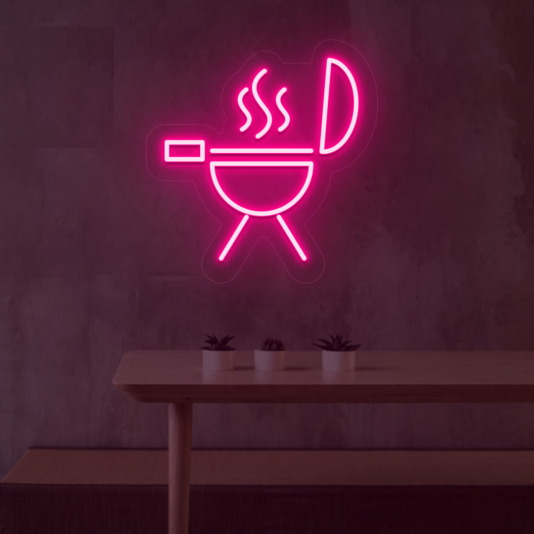 Stylish pink LED BBQ neon sign grill machine design mounted on wall.