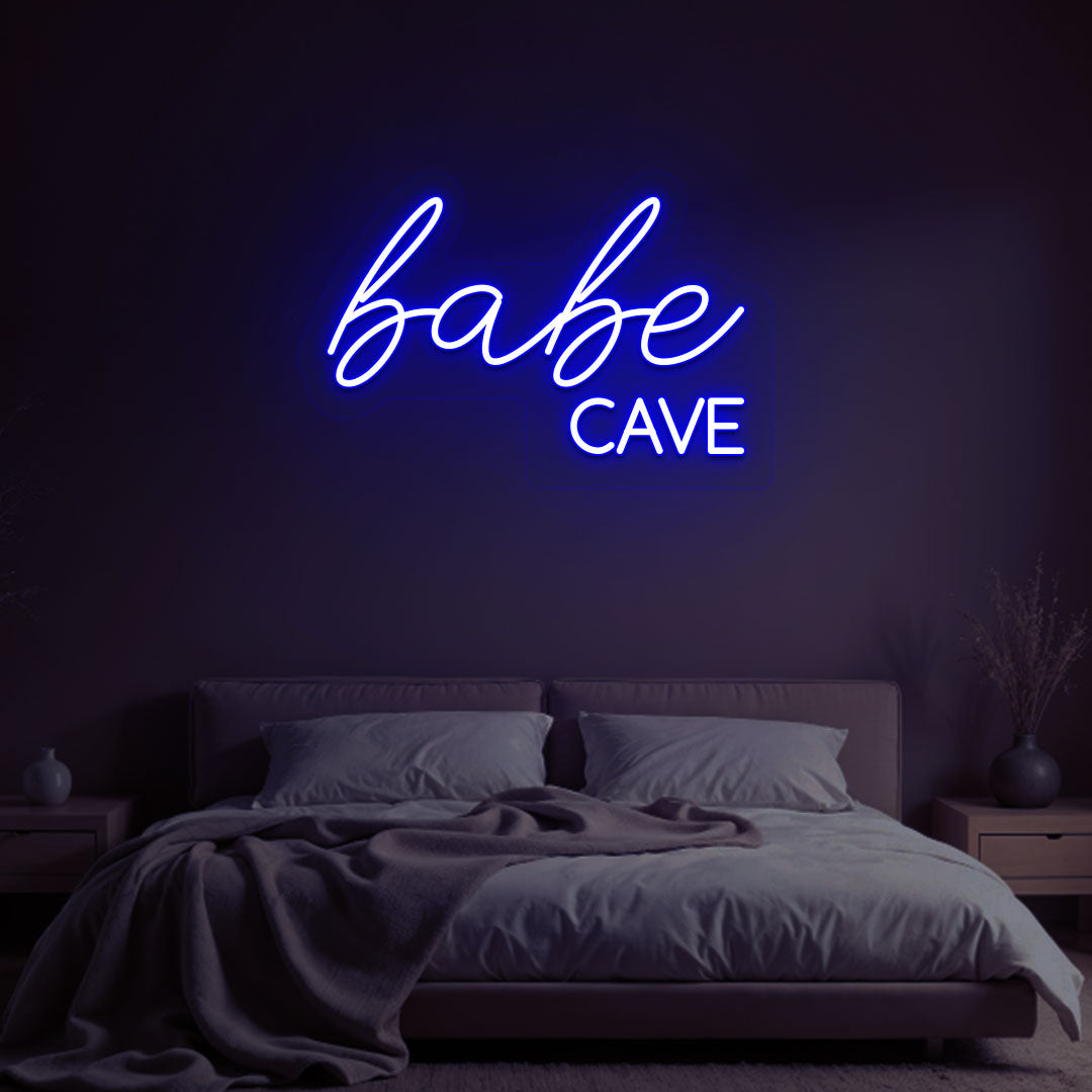 Stylish blue LED babe cave neon sign glowing on the wall. Perfect for bedroom wall décor, dressing rooms, personal spaces, and gifts.
