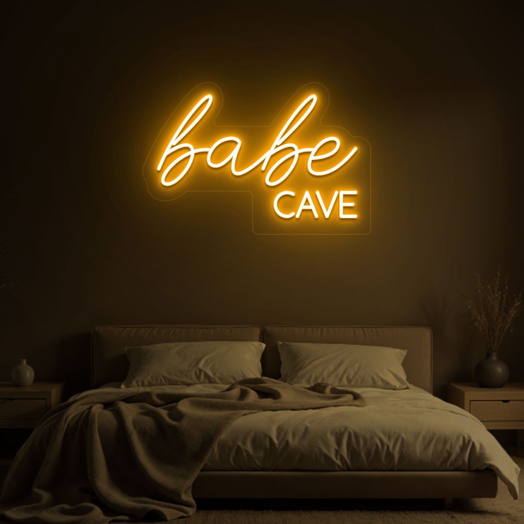 Stylish orange LED babe cave neon sign glowing on the wall. Perfect for bedroom wall décor, dressing rooms, personal spaces, and gifts.