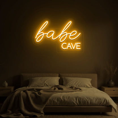 Stylish orange LED babe cave neon sign glowing on the wall. Perfect for bedroom wall décor, dressing rooms, personal spaces, and gifts.