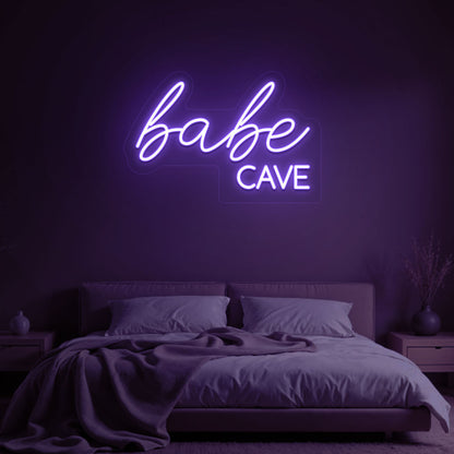 Stylish purple LED babe cave neon sign glowing on the wall. Perfect for bedroom wall décor, dressing rooms, personal spaces, and gifts.