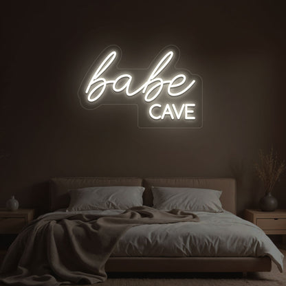 Stylish warm white LED babe cave neon sign glowing on the wall. Perfect for bedroom wall décor, dressing rooms, personal spaces, and gifts.