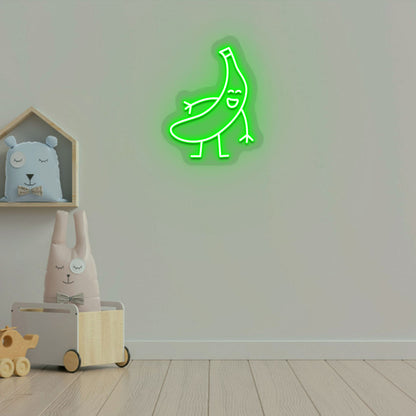 Image of a banana neon sign glowing on a kid's bedroom wall in green color.