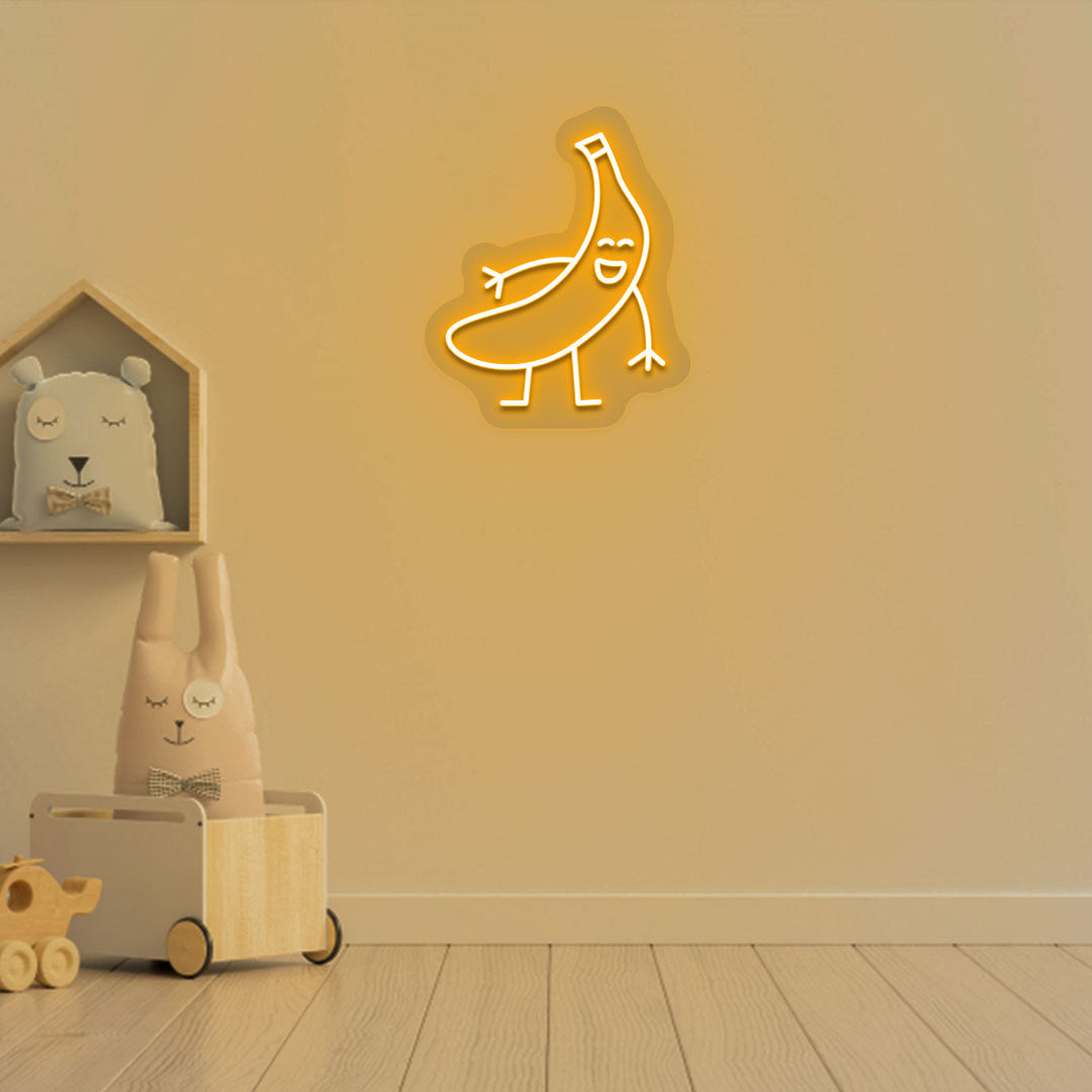 Playroom wall decor with a banana neon sign in orange LED. Perfect for kids’ rooms, nursery wall décor, and bedroom décor.
