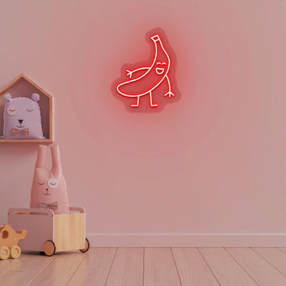 Image of a banana neon sign glowing on a kid's bedroom wall in red color.
