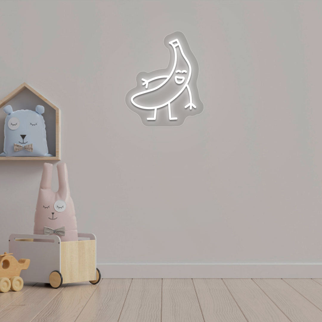 Image of a banana neon sign glowing on a kid's bedroom wall in white color.