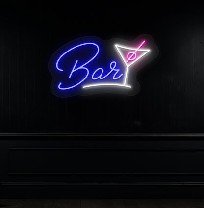 Image of a bar cocktail neon sign in blue LED glowing on a modern bar wall with a cocktail glass.