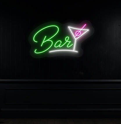 Modern green LED bar neon sign with cocktail glass hanging on a dark wall. 