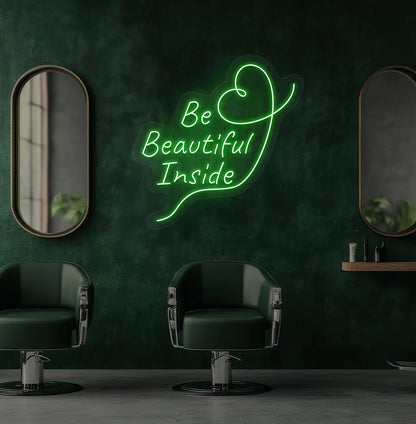Modern salon aesthetic wall with "be beautiful inside" neon sign glowing green.