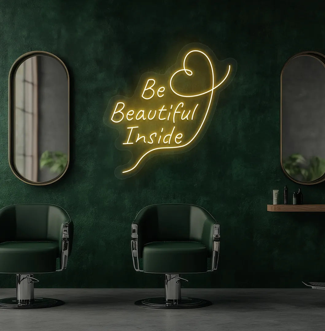 Modern salon aesthetic wall with "be beautiful inside" neon sign glowing orange.