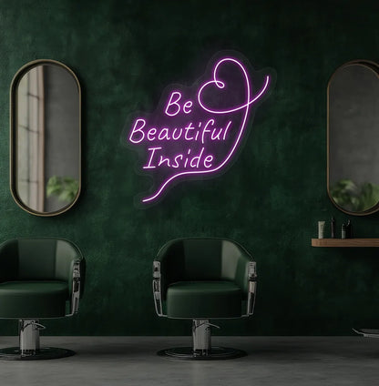 Modern salon aesthetic wall with "be beautiful inside" neon sign glowing purple.