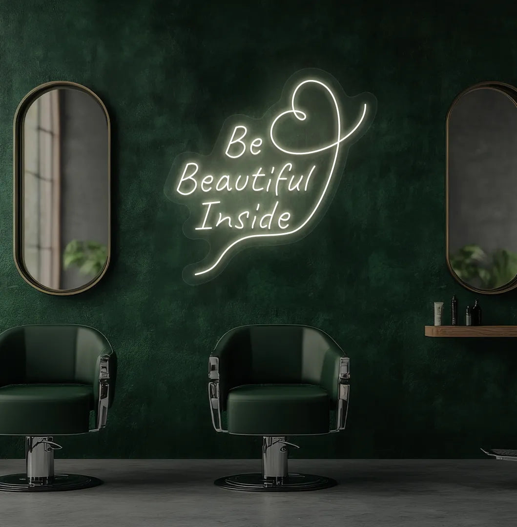 Modern salon aesthetic wall with "be beautiful inside" neon sign glowing warm white.