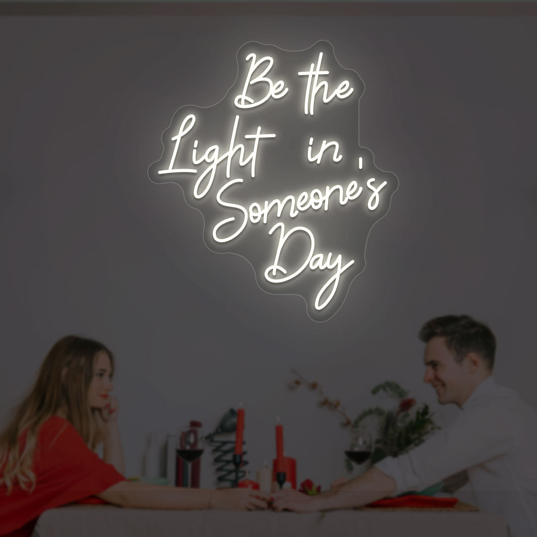 Aesthetic wall with "Be the light in someone's day" warm white neon sign. 