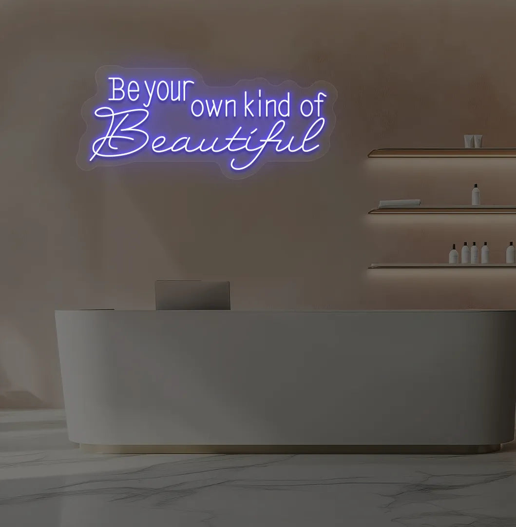 Image of a bright blue "be your own kind of beautiful" neon sign for salon wall decor.